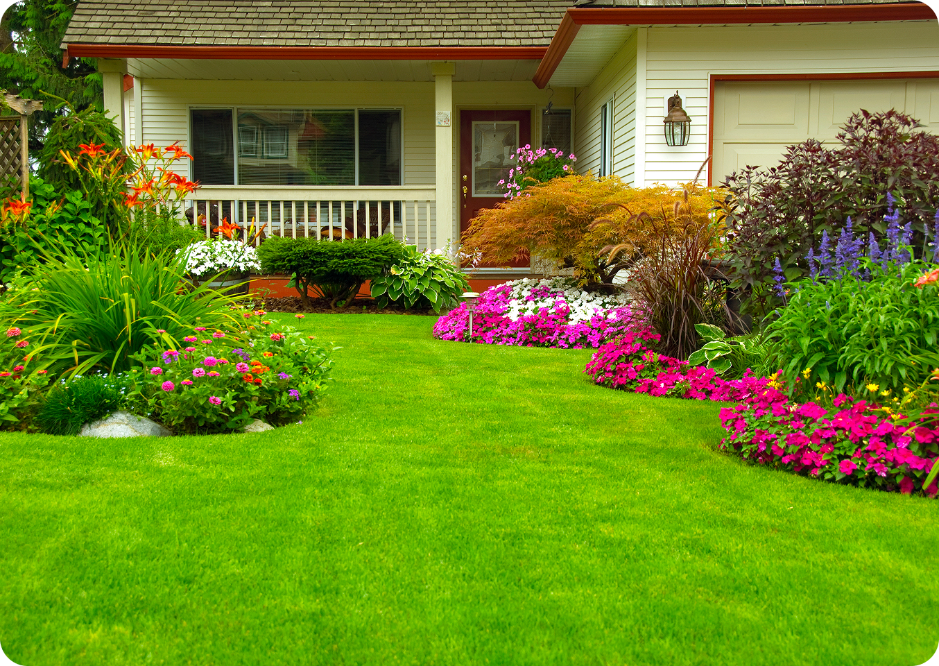 House with vibrant garden and green lawn.