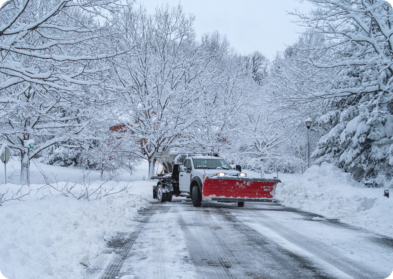Snow plow clearing a snowy road.